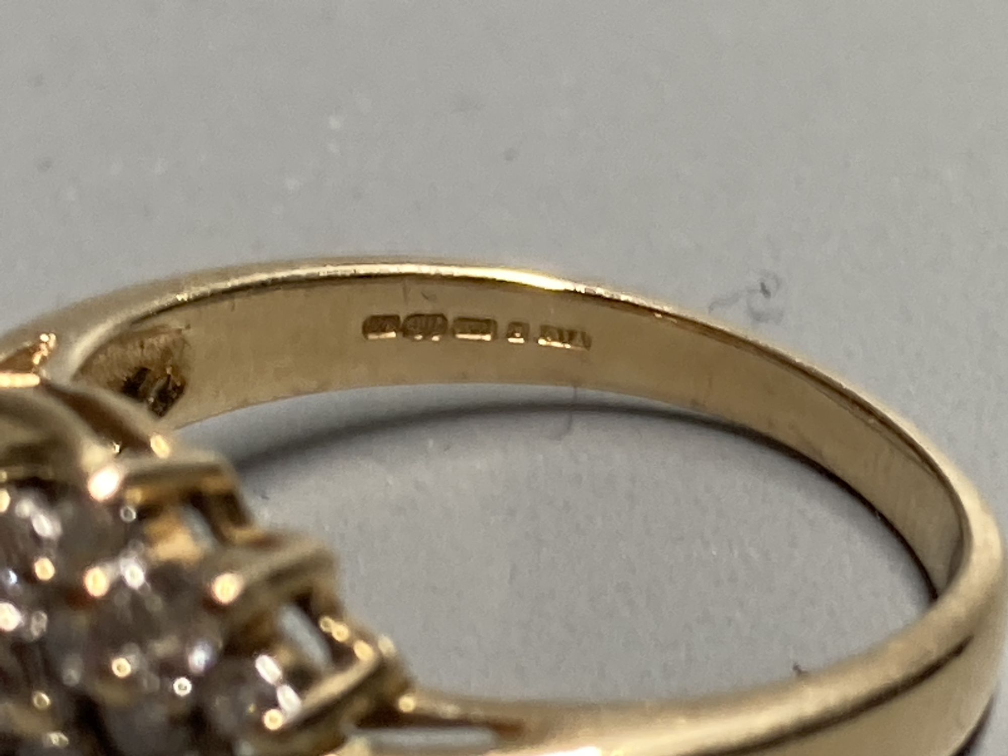 A modern 18ct gold and nineteen stone three stone three row diamond crossover ring, size N, gross 4.3 grams.